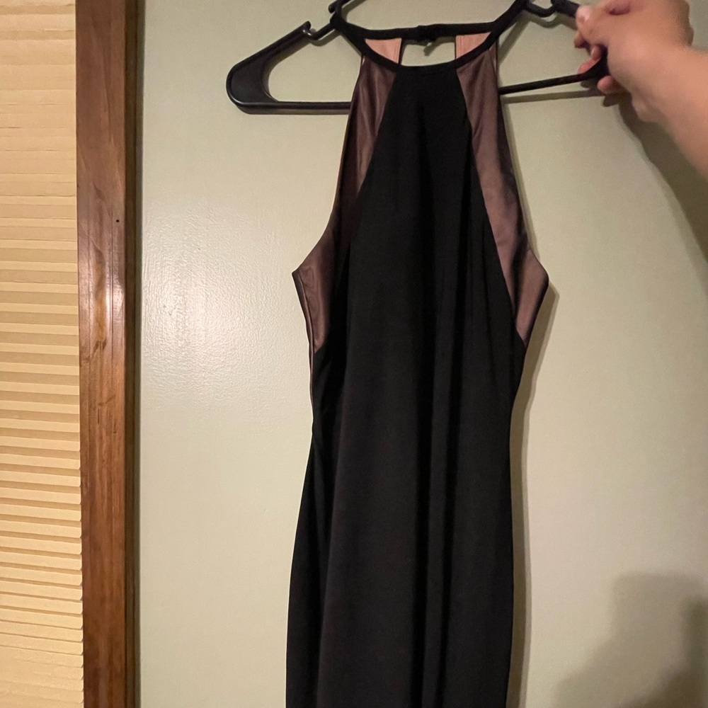 Black halter dress with open back. Worn twice. In great condition. Tea length